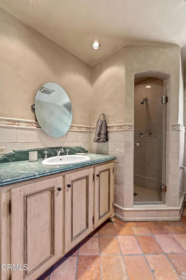 3325 Figueroa Mountain Rd, Los Olivos, CA 93441 - full bathroom featuring a shower stall, vanity, recessed lighting, stone tile flooring, and tile walls