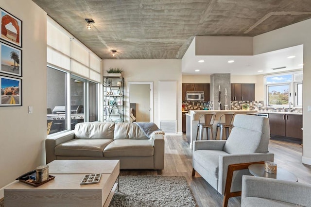 living area with visible vents and light wood-style flooring