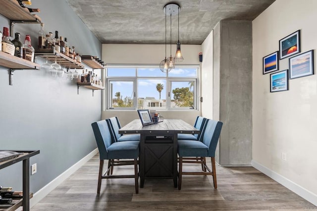 dining area with wood finished floors and baseboards
