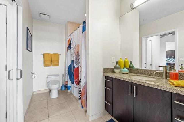 full bath featuring vanity, toilet, baseboards, and tile patterned floors