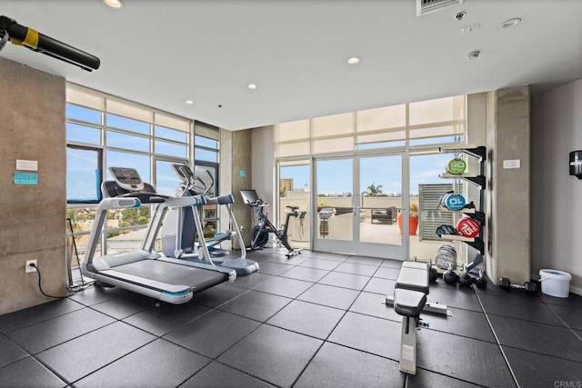 gym featuring plenty of natural light, a wall of windows, and recessed lighting
