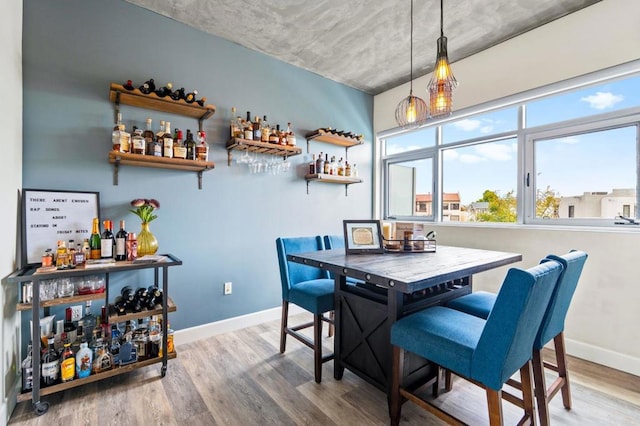 3740 Park Blvd Unit 209, San Diego, CA 92103 - dining area featuring a bar, wood finished floors, and baseboards