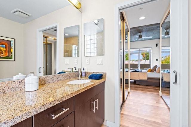 3740 Park Blvd Unit 209, San Diego, CA 92103 - bathroom with vanity, ceiling fan, wood finished floors, ensuite bath, and a shower with shower door
