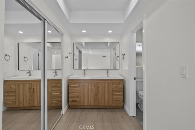 24431 La Glorita Cir, Newhall, CA 91321 - full bathroom featuring recessed lighting, two vanities, a sink, and wood finished floors