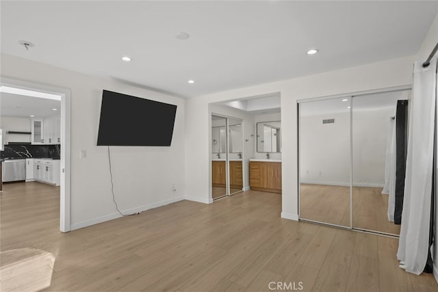 24431 La Glorita Cir, Newhall, CA 91321 - unfurnished bedroom with recessed lighting, connected bathroom, baseboards, and light wood-style floors