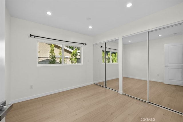 24431 La Glorita Cir, Newhall, CA 91321 - unfurnished bedroom with wood finished floors, baseboards, multiple closets, and recessed lighting