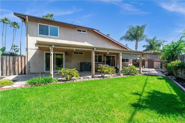 rear view of house featuring a fenced backyard, a patio, stucco siding, and central AC
