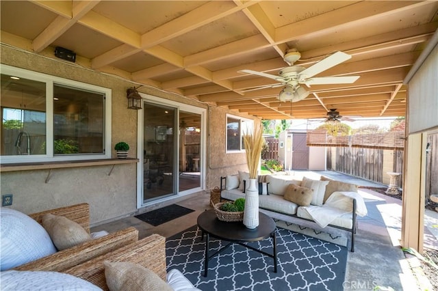 view of patio with an outdoor living space, an outdoor structure, ceiling fan, a fenced backyard, and a storage unit