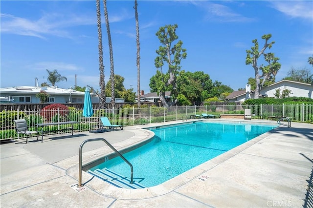 community pool featuring fence and a patio