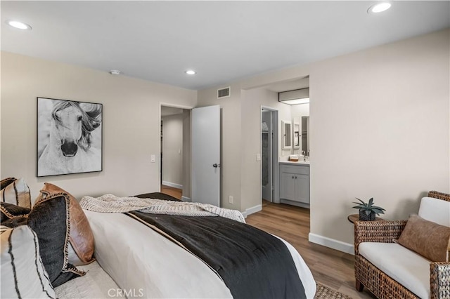 bedroom featuring light wood finished floors, visible vents, baseboards, and recessed lighting