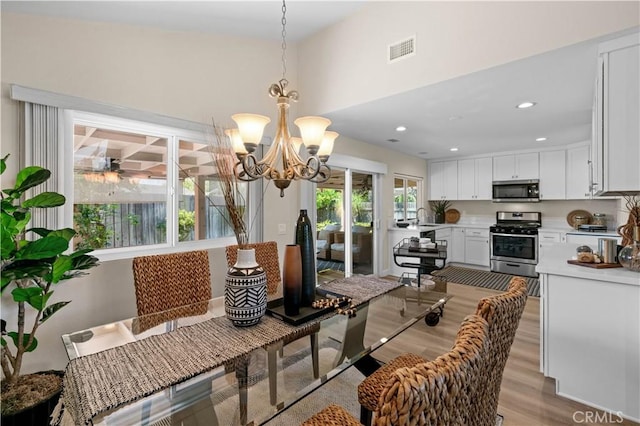 dining area featuring recessed lighting, a notable chandelier, light wood-style flooring, and visible vents