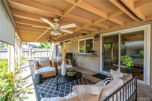 view of patio with an outdoor living space, visible vents, ceiling fan, and fence