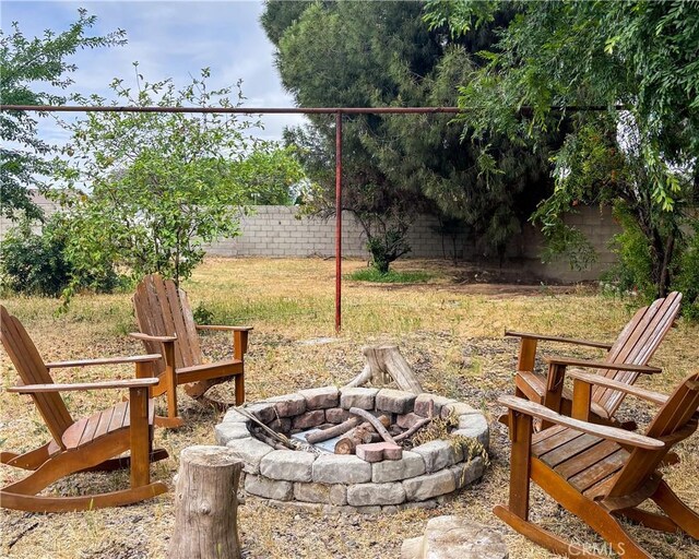 644 Whittendale St, Bakersfield, CA 93307 - view of yard featuring a fenced backyard and a fire pit