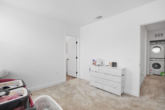 2152 Reed Dr, San Diego, CA 92154 - bedroom with visible vents, stacked washer and clothes dryer, and light colored carpet