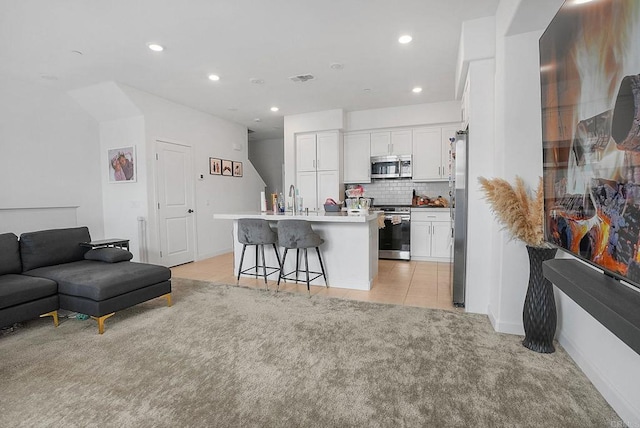 2152 Reed Dr, San Diego, CA 92154 - living area featuring recessed lighting, light tile patterned floors, baseboards, visible vents, and light carpet