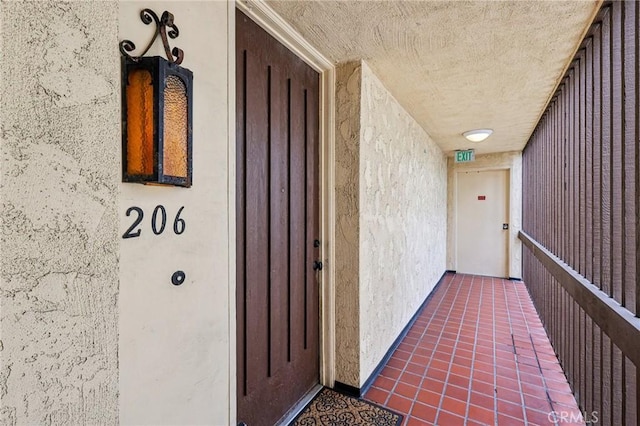 view of exterior entry featuring stucco siding