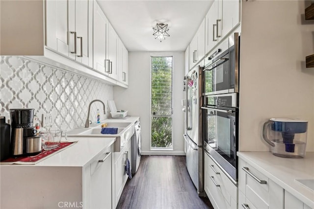 kitchen with high end fridge, dark wood finished floors, white cabinetry, decorative backsplash, and light countertops