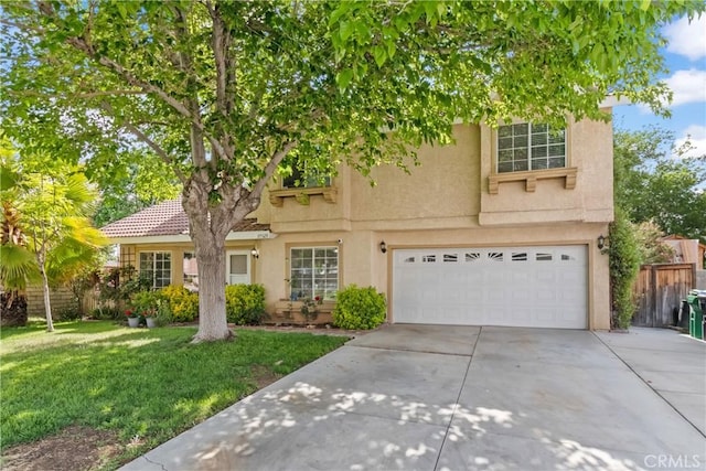 traditional-style home featuring concrete driveway, an attached garage, stucco siding, and a front lawn