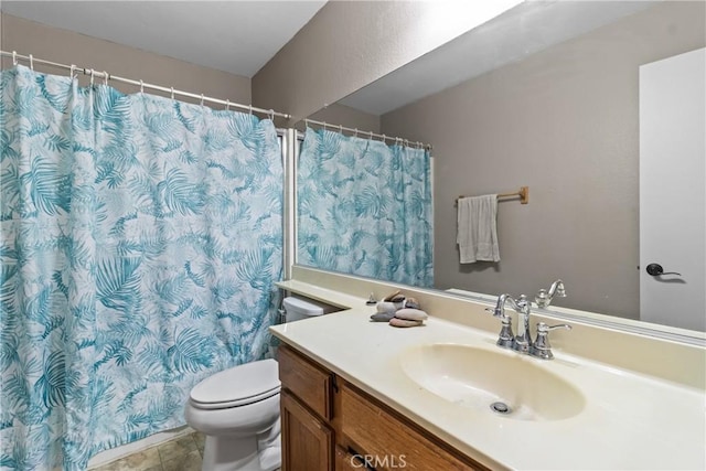 bathroom featuring toilet, vanity, and curtained shower
