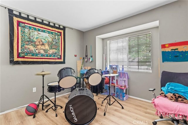 recreation room with wood finished floors and baseboards