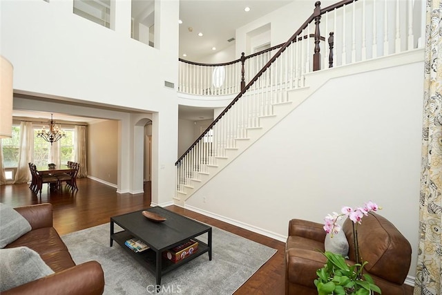 1472 Nicolas Way, Fullerton, CA 92833 - living room featuring a chandelier, wood finished floors, stairs, a towering ceiling, and baseboards