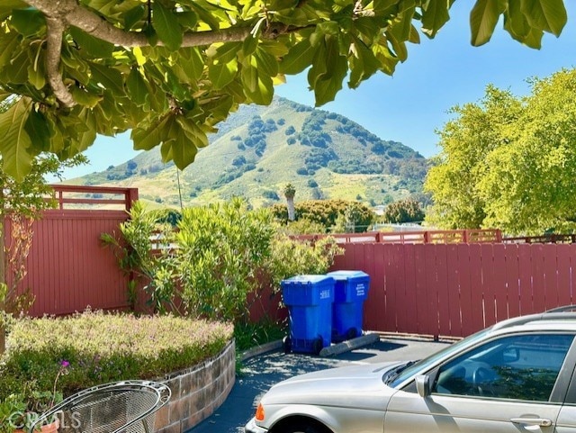 exterior space with a mountain view and fence