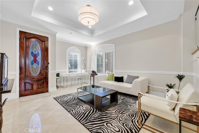 living area featuring recessed lighting, ornamental molding, a decorative wall, a wainscoted wall, and a raised ceiling