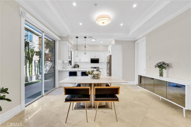 dining room with baseboards, a raised ceiling, ornamental molding, and recessed lighting