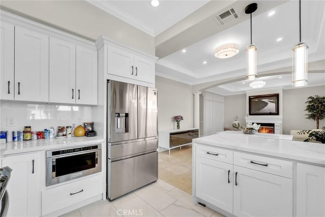 kitchen with visible vents, crown molding, white cabinets, appliances with stainless steel finishes, and ornate columns