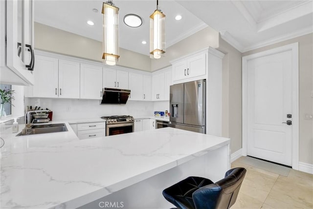 kitchen with a sink, a peninsula, light stone countertops, and appliances with stainless steel finishes