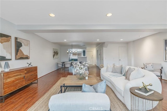 living area featuring an inviting chandelier, recessed lighting, and wood finished floors
