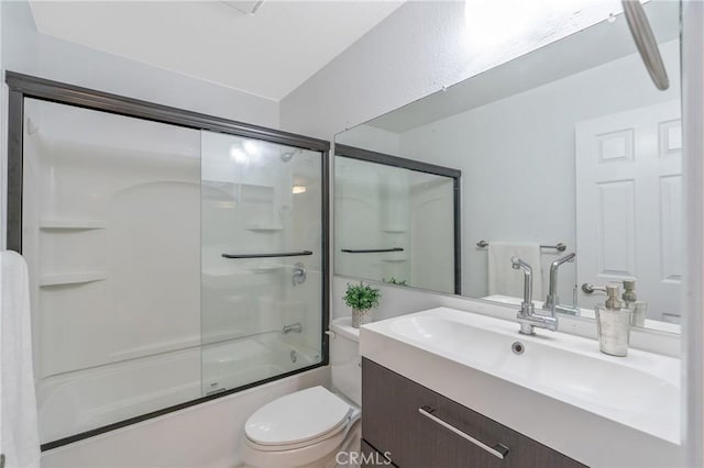 full bath featuring toilet, vanity, and combined bath / shower with glass door