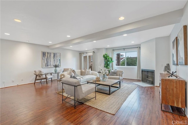 living area with recessed lighting, baseboards, a fireplace with flush hearth, and hardwood / wood-style flooring