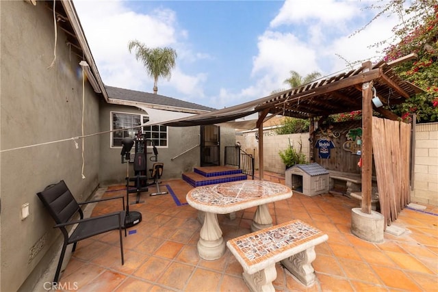 view of patio with a pergola and fence