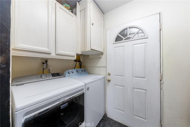 clothes washing area with washer and clothes dryer and cabinet space
