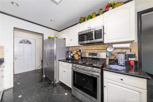 kitchen with granite finish floor, decorative backsplash, dark countertops, white cabinets, and appliances with stainless steel finishes