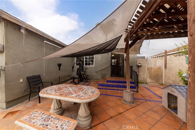 view of patio with a pergola and fence
