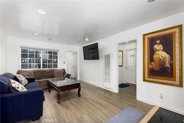 living room featuring baseboards, recessed lighting, visible vents, and wood finished floors