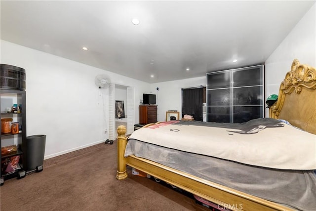 carpeted bedroom featuring baseboards and recessed lighting
