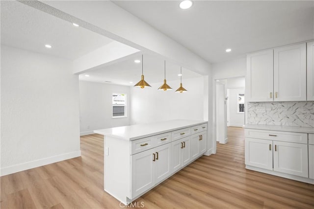 781 Sycamore Ct, Upland, CA 91786 - kitchen with backsplash, light countertops, light wood finished floors, white cabinetry, and recessed lighting