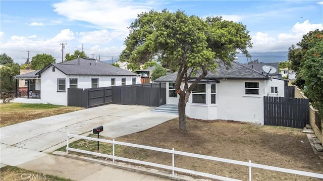 781 Sycamore Ct, Upland, CA 91786 - view of front of property featuring stucco siding, a fenced front yard, driveway, and a shingled roof