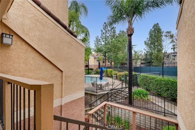 exterior space with fence and a community pool
