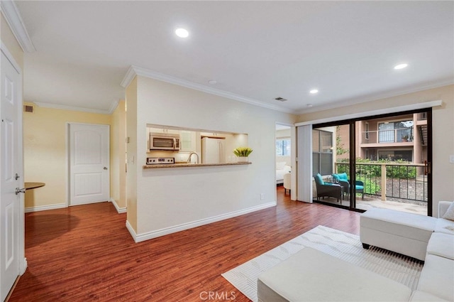 living room with crown molding, baseboards, and wood finished floors