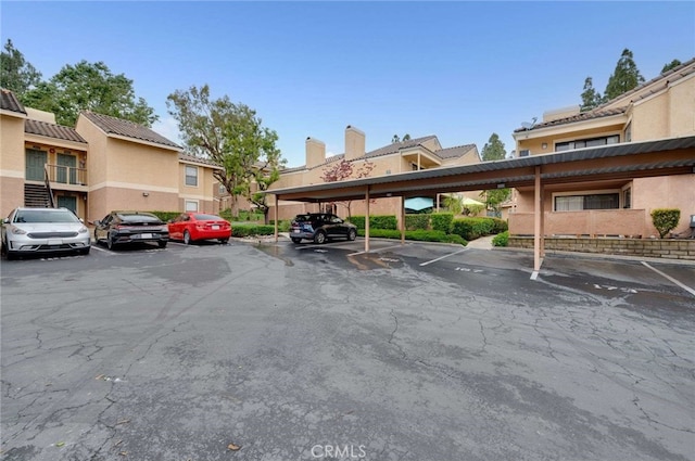 covered parking lot featuring a residential view