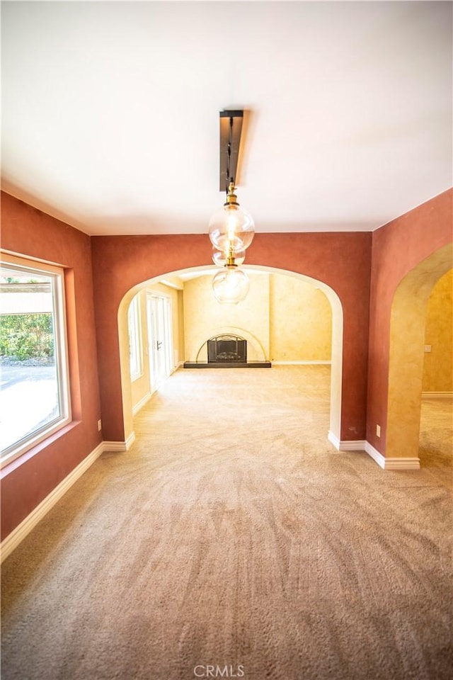 3926 Corte Cancion, Thousand Oaks, CA 91360 - unfurnished living room featuring carpet, baseboards, and arched walkways