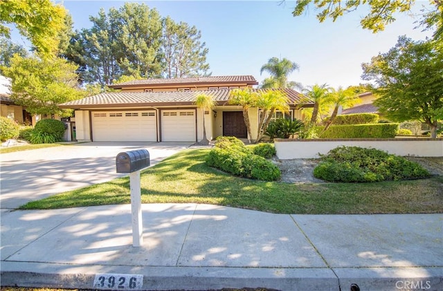 3926 Corte Cancion, Thousand Oaks, CA 91360 - view of front facade with concrete driveway, stucco siding, a tiled roof, and a garage