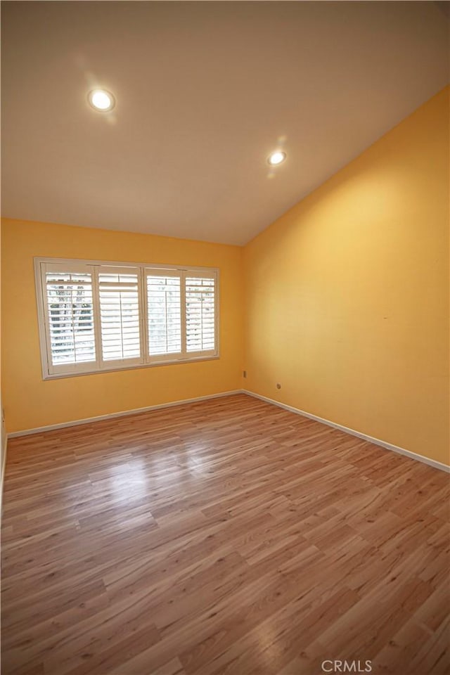 3926 Corte Cancion, Thousand Oaks, CA 91360 - unfurnished room with lofted ceiling, baseboards, recessed lighting, and wood finished floors