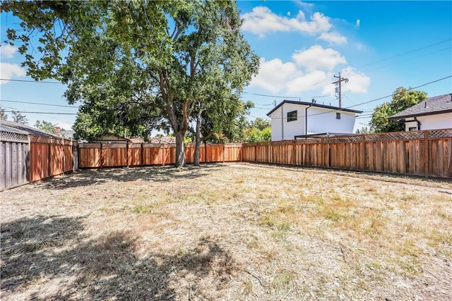 view of yard with a fenced backyard