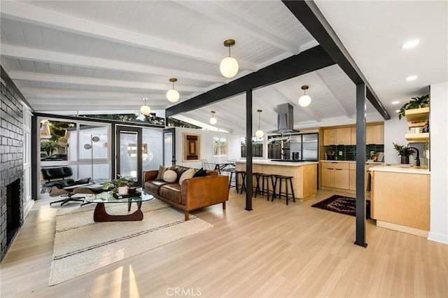 3130 Kallin Ave, Long Beach, CA 90808 - living area with light wood finished floors and a brick fireplace