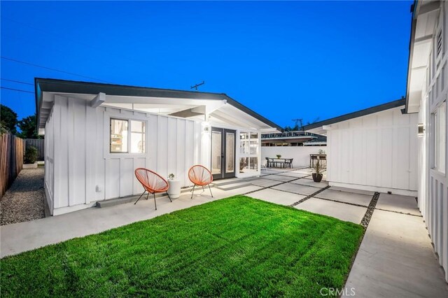 3130 Kallin Ave, Long Beach, CA 90808 - rear view of property with board and batten siding, a patio area, and french doors